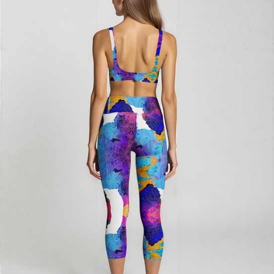 Back view of high-waisted Ocean Mirage Yoga Capri Leggings in ocean-inspired abstract blue, purple, and gold print, shown on a model’s capri-length fit.