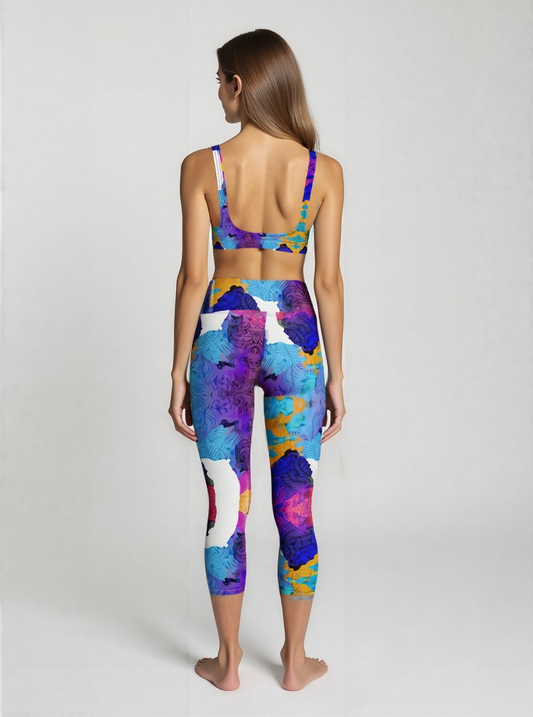 Back view of high-waisted Ocean Mirage Yoga Capri Leggings in ocean-inspired abstract blue, purple, and gold print, shown on a model’s capri-length fit.