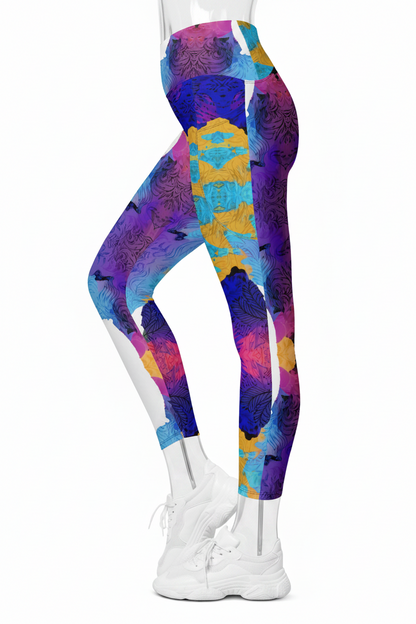 A mannequin modeling high-waisted leggings with a bold abstract watercolor-style print in purple, blue, pink, yellow, and teal, paired with white sneakers against a plain white background.