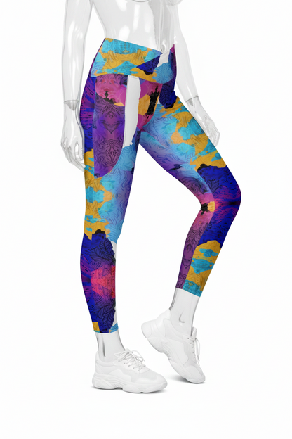 A mannequin wearing high-waisted leggings with a vibrant abstract floral print in purple, blue, yellow, and pink, paired with white sneakers against a plain white background.
