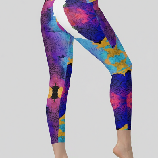 Colorful patterned leggings worn by a person on a gray background