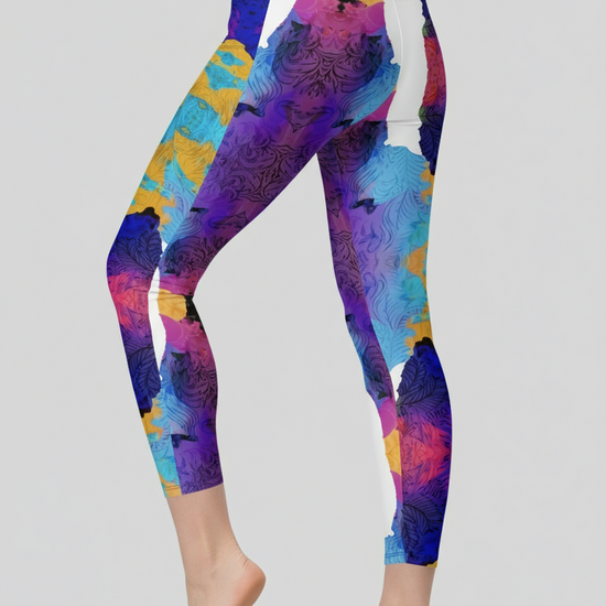 Colorful leggings with abstract design worn by a person on a plain background
