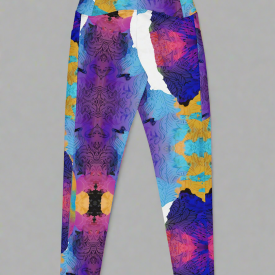 Ocean Mirage Crossover leggings laid flat, back view, showcasing high waistband and symmetrical multicolour abstract pattern with purple, blue, yellow, pink, and black tones on a grey background.