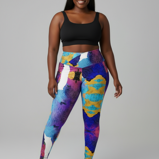 Person wearing colorful leggings and a black sports bra on a gray background
