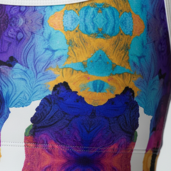 Close-up detail of Ocean Mirage print fabric showing vibrant colors and four-way stretch material