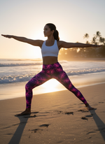 Woman wearing Orchid Current yoga leggings with electric pink and purple kaleidoscope pattern in warrior pose on beach
