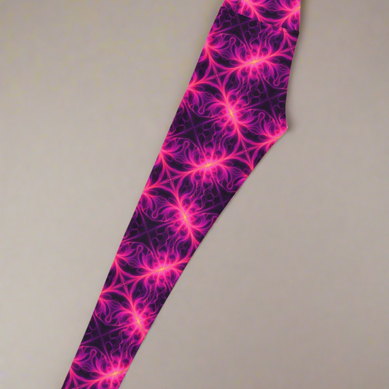 Left-side flat lay of Orchid Current Yoga Leggings featuring a vivid neon pink fractal-inspired pattern on a deep purple background, highlighting the bold and symmetrical design.