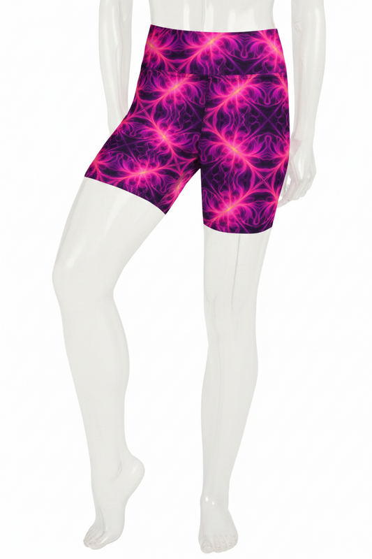 A mannequin modeling high-waisted biker shorts with a vivid magenta and purple fractal pattern against a plain white background.