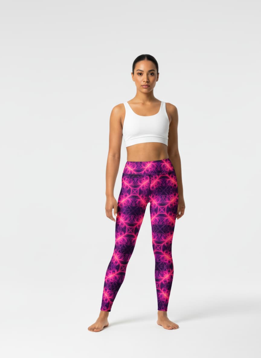 Woman wearing a white tank top and pink and purple tie-dye leggings on a white background