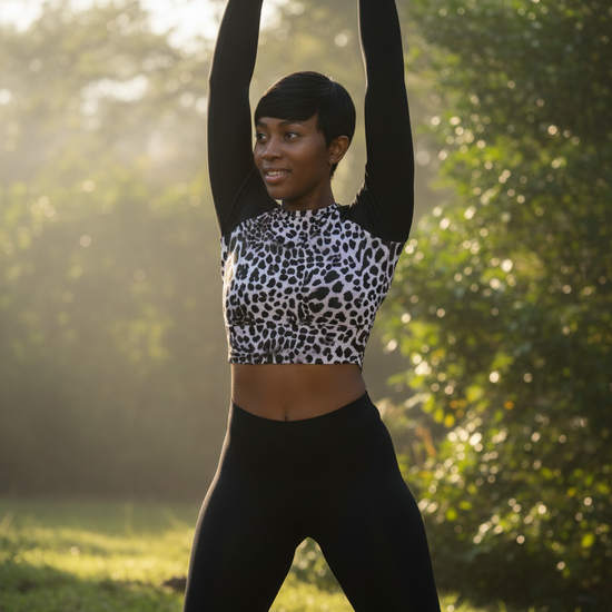 Woman wearing leopard print surf crop top with black sleeves, front view