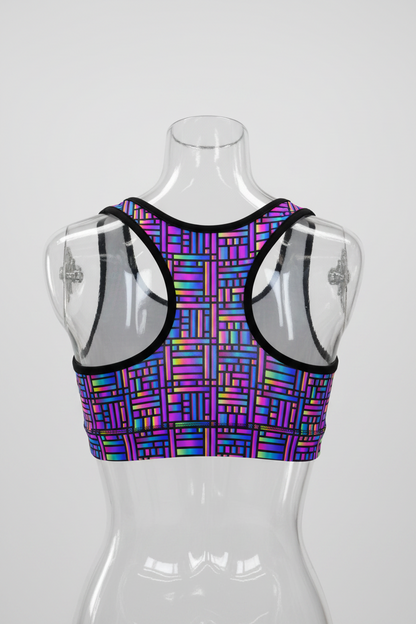 A racerback tank top with a vibrant multicolor geometric pattern of intersecting lines in purple, blue, pink, and green, featuring solid white underarm panels and black trim. 
