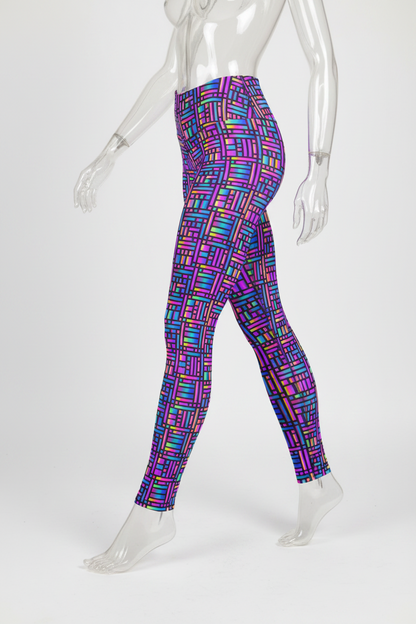 A mannequin wearing high-waisted leggings with a bright multicolor geometric block pattern on a plain white background.