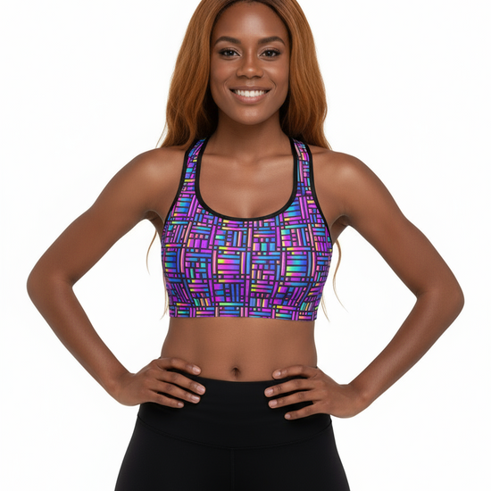 Woman wearing a colorful patterned sports bra and black leggings on a white background