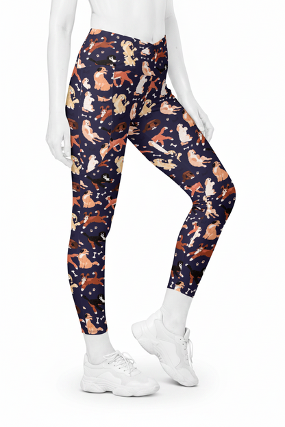 A mannequin modeling high-waisted leggings with an all-over cat print on a dark navy background, paired with white sneakers against a plain white studio background.