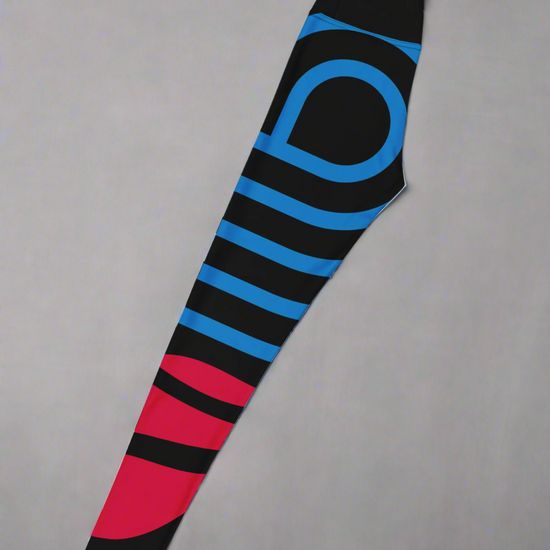 Left side flat lay view of yoga leggings with black, blue, and red stripes on a gray background