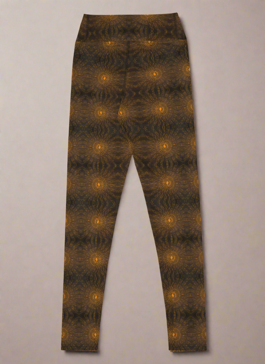 Back-flat product image of Rustic Amber leggings showing the full front panel and high-rise waistband, symmetrical mirrored brown and black kaleidoscope pattern with regularly spaced glowing orange circular motifs, full-length silhouette on a neutral background.
