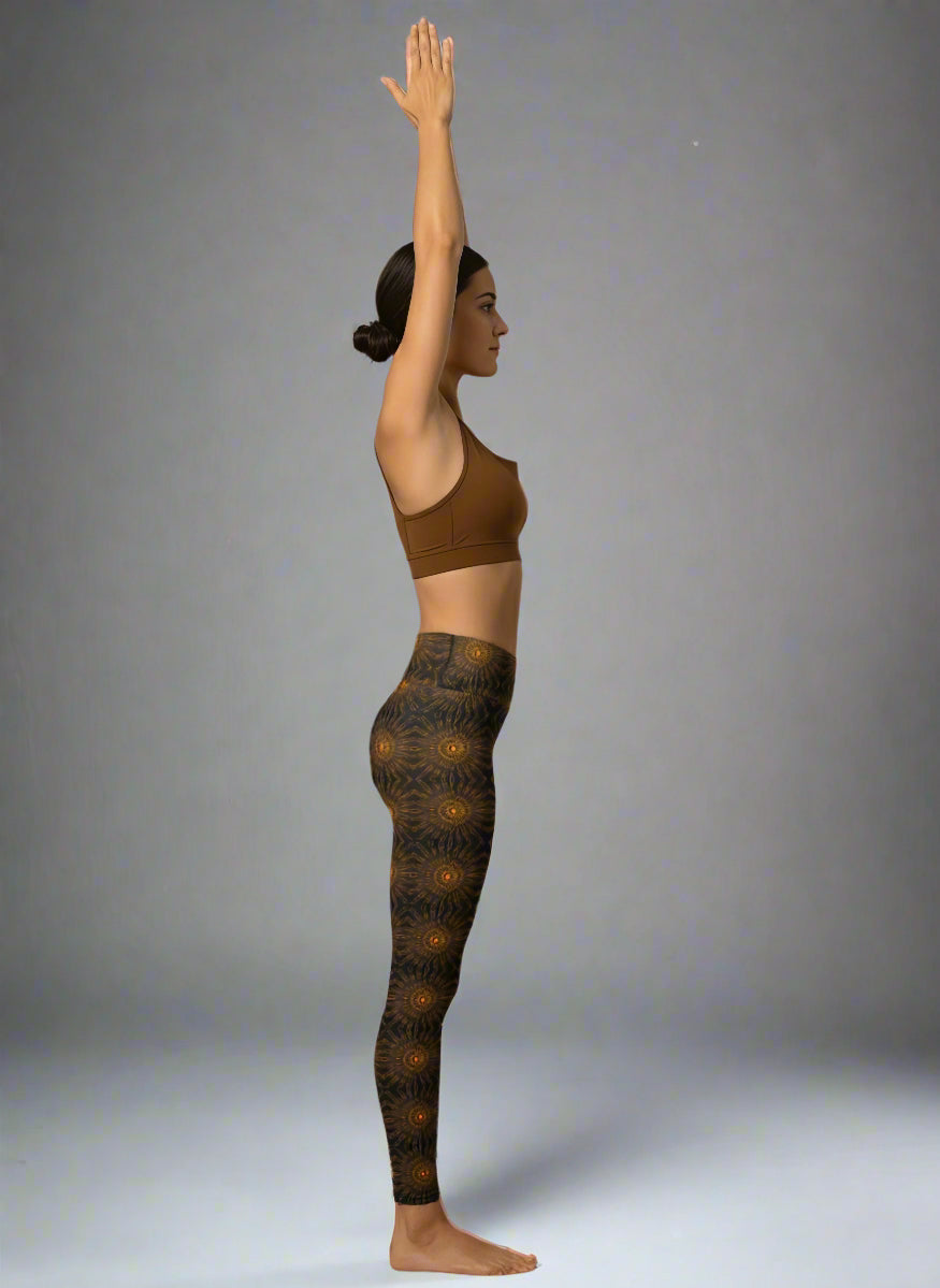 Person wearing a brown sports bra and patterned leggings against a gray background