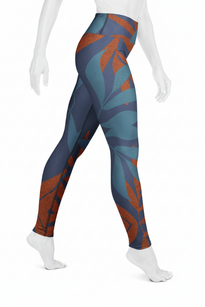 A mannequin wearing high-waisted leggings with an abstract leaf pattern in slate blue, teal, and rust orange, shown from the waist down against a plain white background.