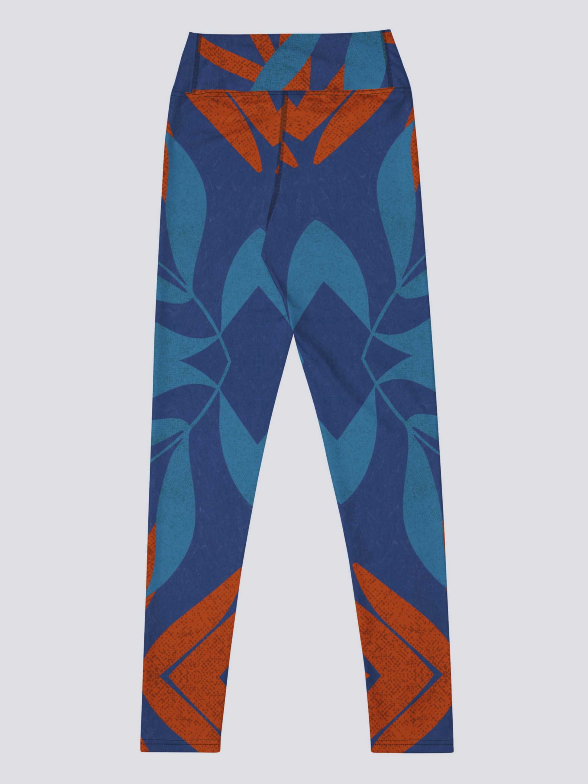 Blue and burnt orange patterned yoga leggings on a light grey background