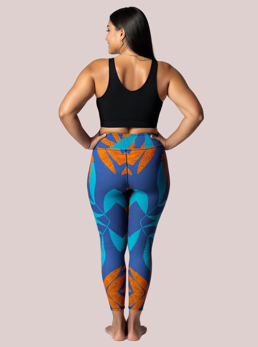 Back view of a barefoot model wearing Pixie & Sherbet’s Rustic Rhythm Yoga leggings with vibrant blue and orange geometric patterns, paired with a black sleeveless crop top, standing confidently against a white background.
This version keeps the tone consistent with your brand’s empowering aesthetic while spotlighting the leggings’ symmetry and colou story. If you’re building a full campaign set, I can help you weave a cohesive narrative across all alt texts to enhance SEO and visual storytelling. Just say 