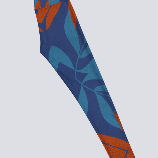 Right side of blue and burnt orange patterned yoga leggings on a light grey background
