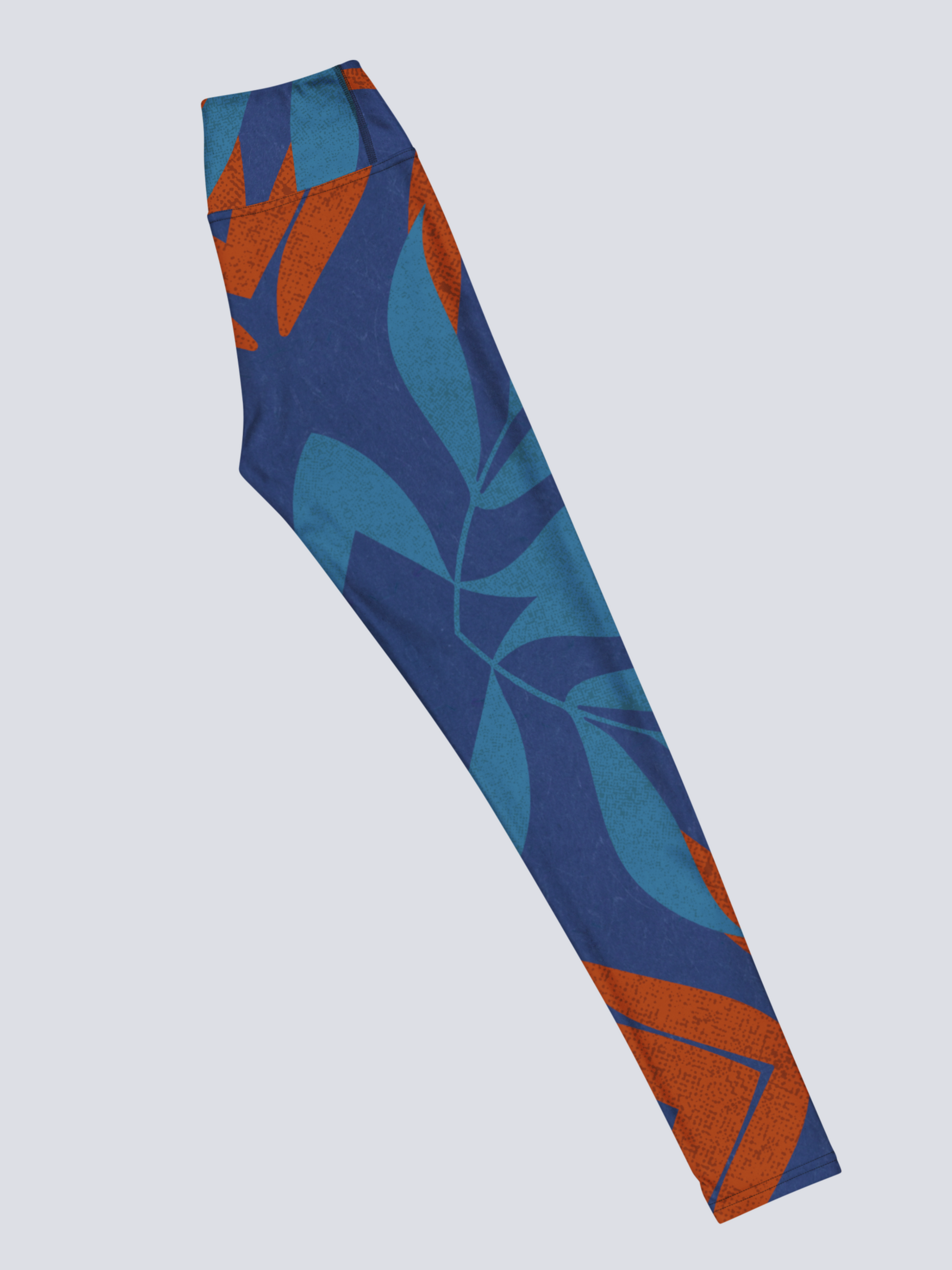 Right side of blue and burnt orange patterned yoga leggings on a light grey background