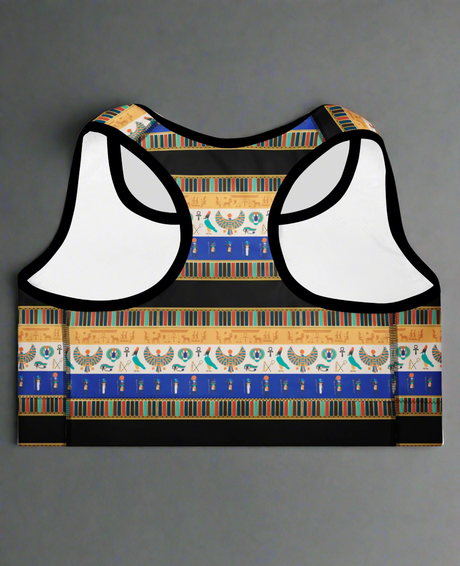 back view of Sapphire Essential Active Bra featuring blue, gold, black, and white Egyptian-inspired pattern with hieroglyphics, Eye of Horus, and scarab motifs; displayed against a plain background.