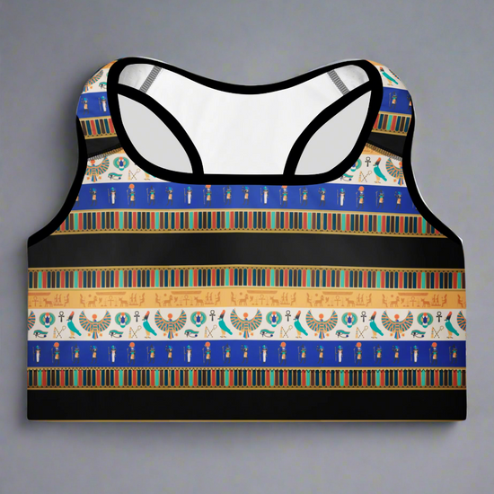 Front view of Sapphire Essential Active Bra featuring blue, gold, black, and white Egyptian-inspired pattern with hieroglyphics, Eye of Horus, and scarab motifs; displayed against a plain background.