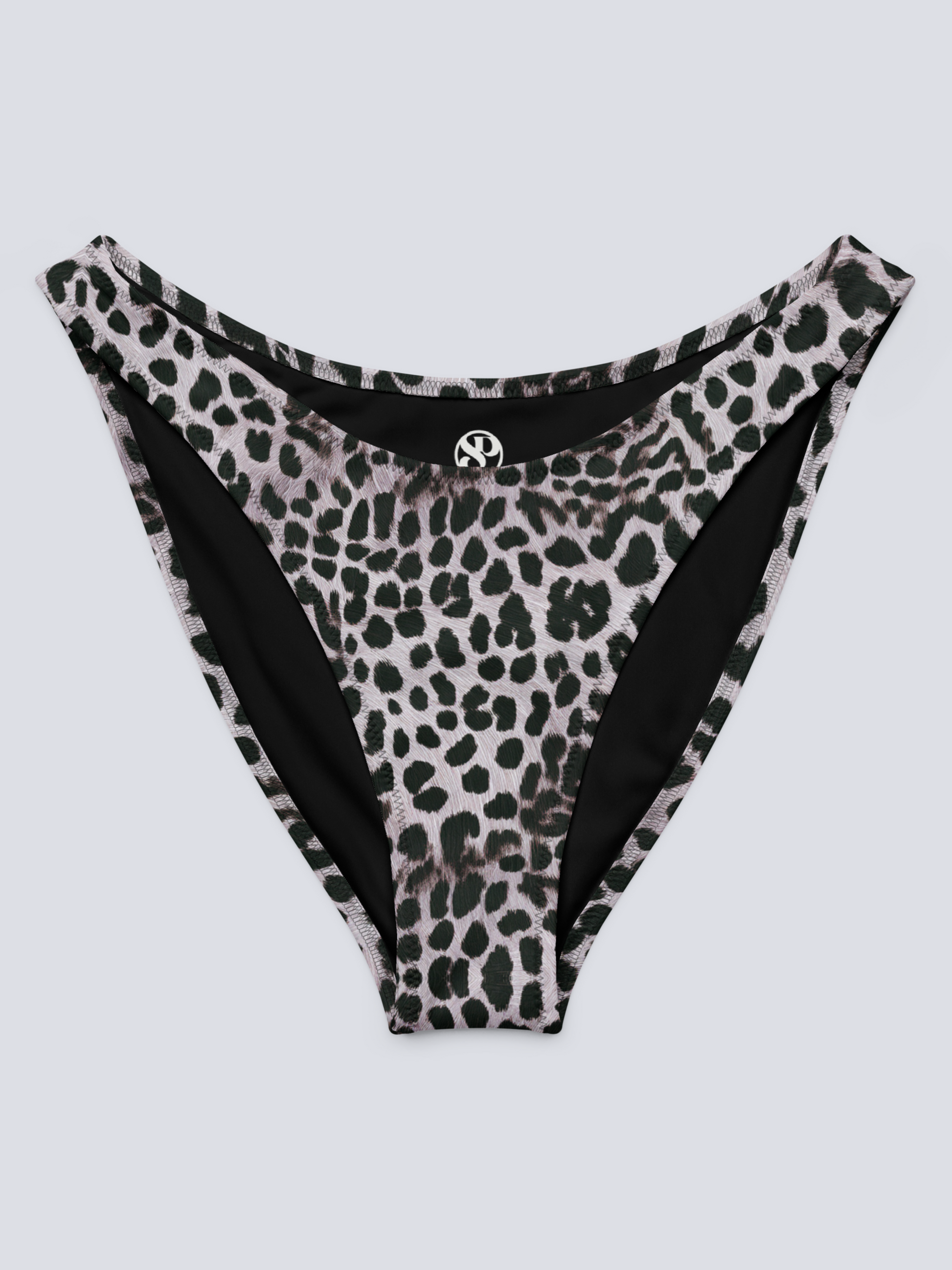 Flat-lay of Savannah Charge Cheeky Bikini Bottoms in monochrome leopard print with high-cut silhouette and Pixie & Sherbet logo detail – bold, sculpting swimwear.