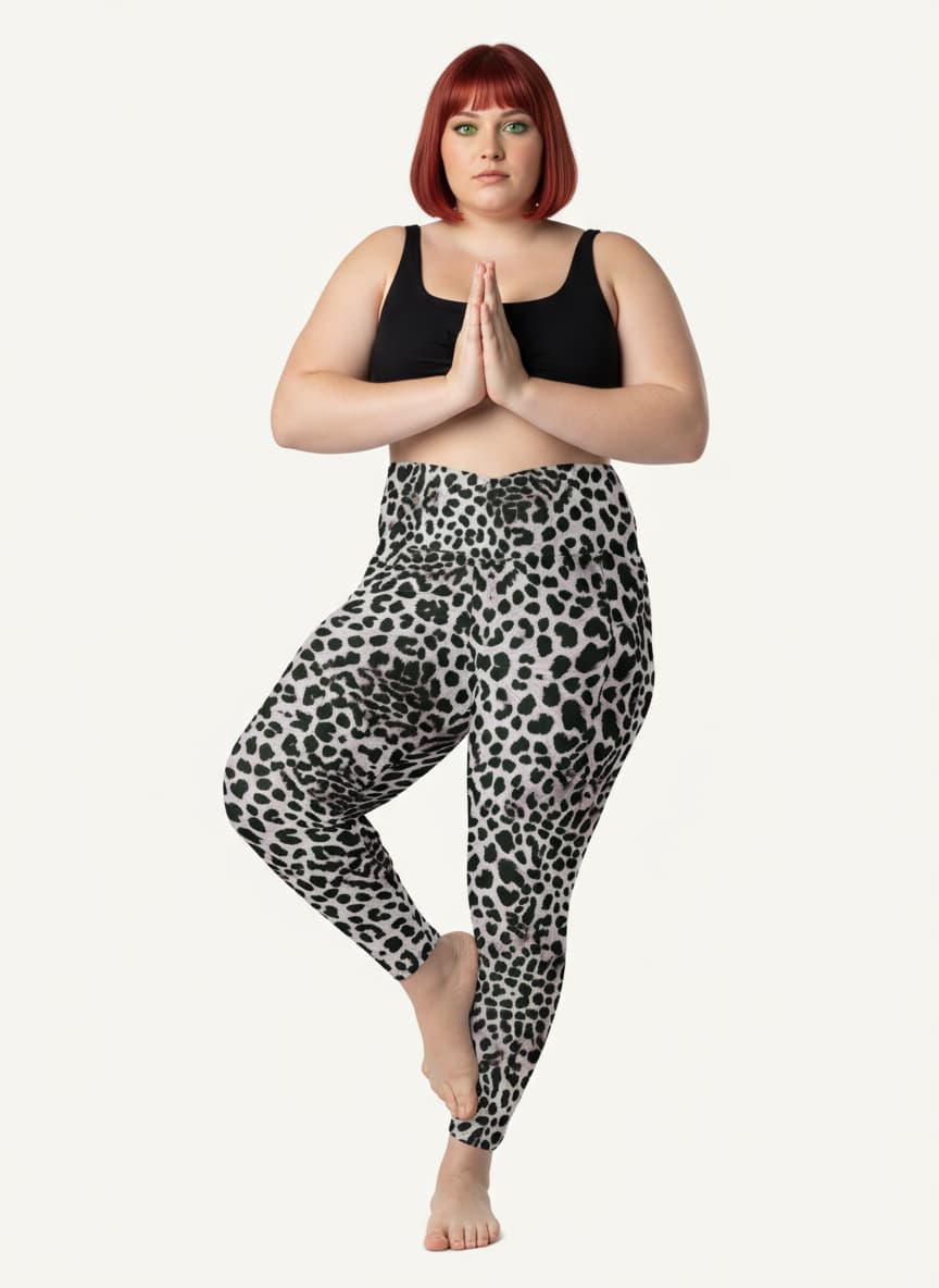 Person wearing black tank top and leopard print leggings on a white background