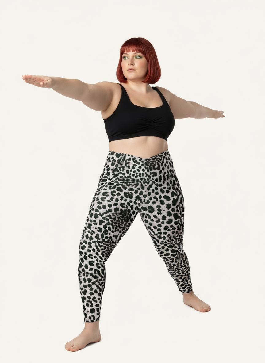 Person wearing black tank top and leopard print leggings on a white background