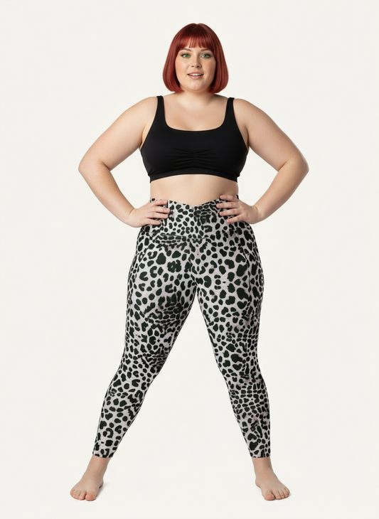 Person wearing black tank top and leopard print leggings on a white background