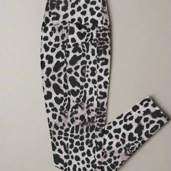 Left side flat lay view of Savannah Charge Crossover Leggings with pockets and leopard print, on a white background