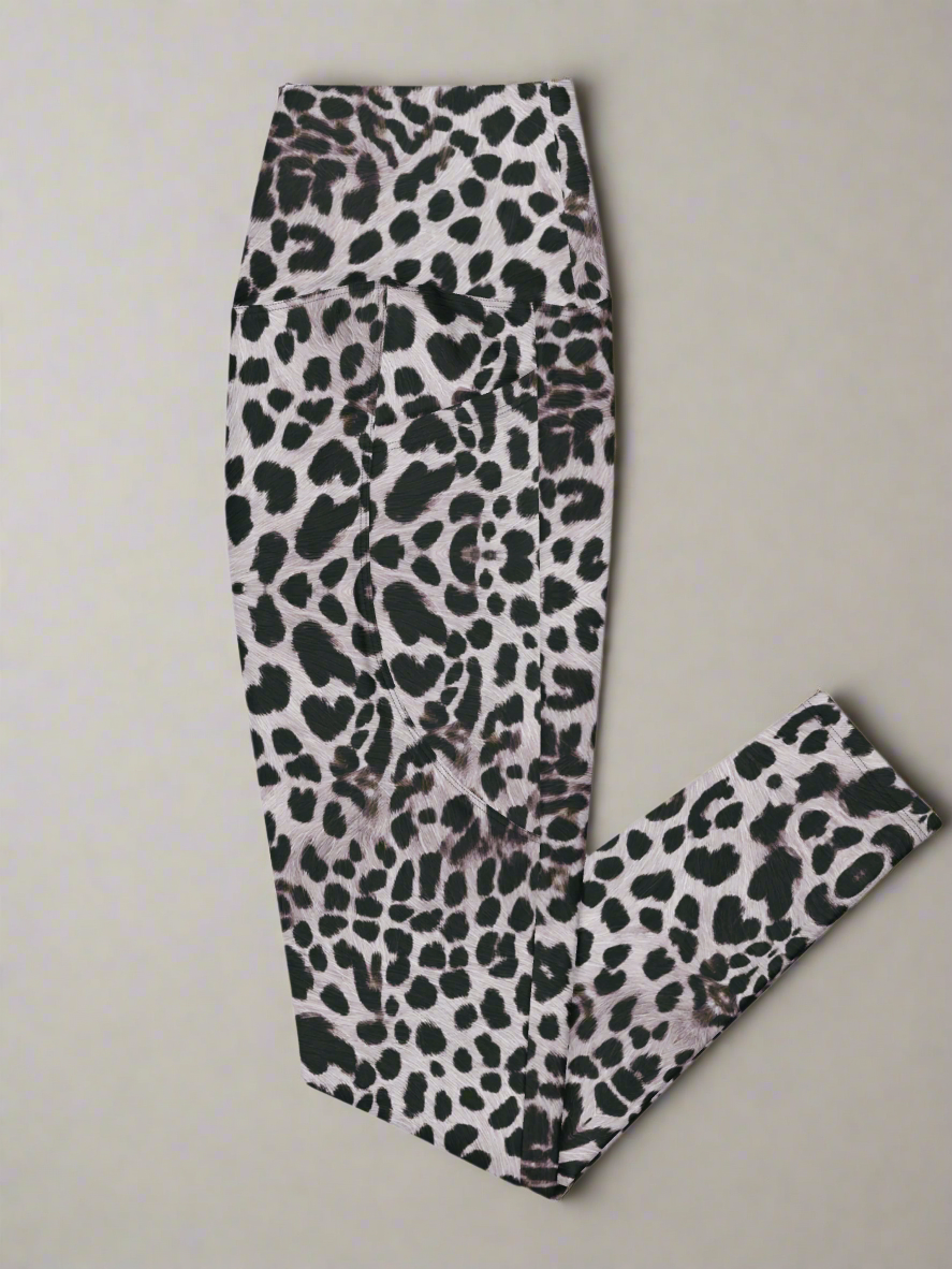 Left side flat lay view of Savannah Charge Crossover Leggings with pockets and leopard print, on a white background