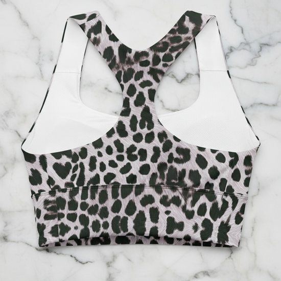 Leopard print sports bra on a white marble background