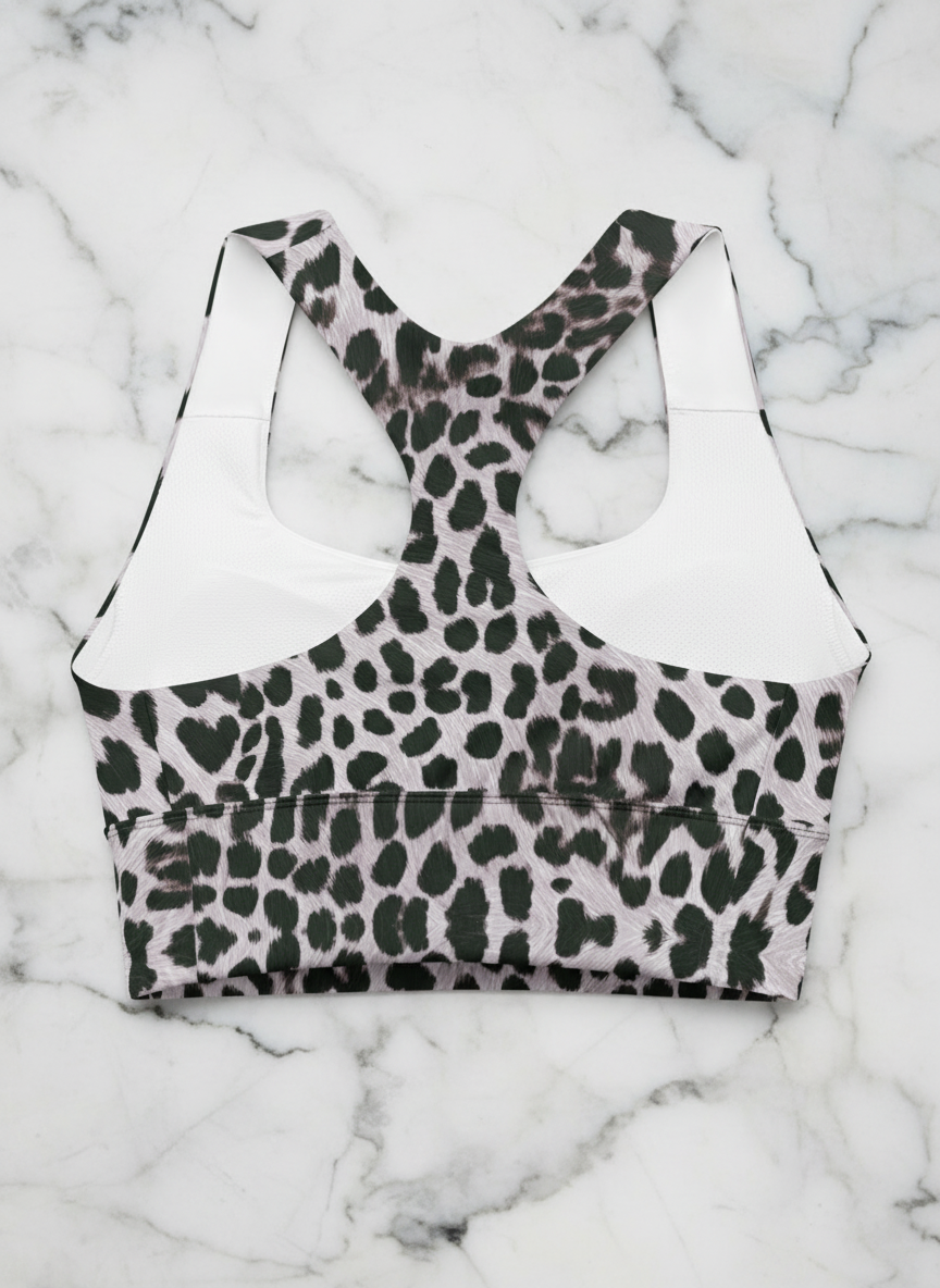 Leopard print sports bra on a white marble background