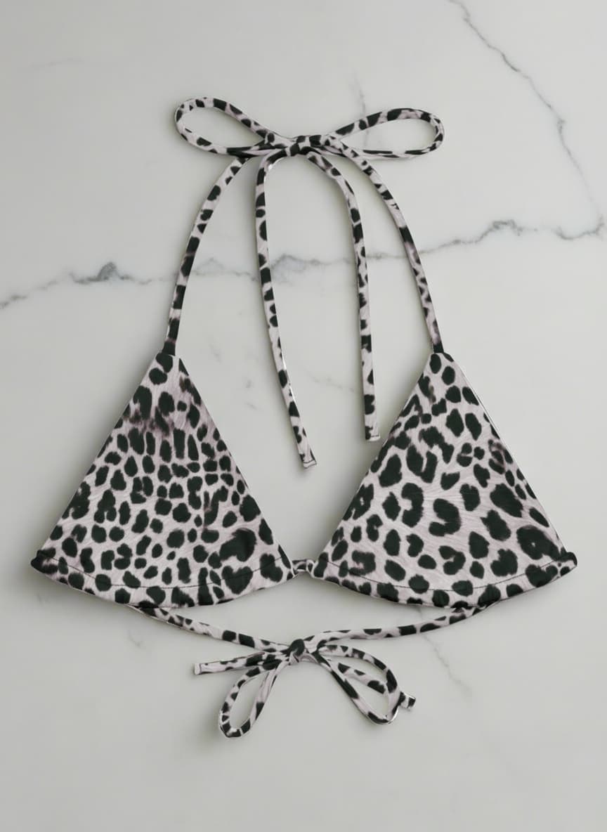 Leopard print bikini top and bottom on a marble background