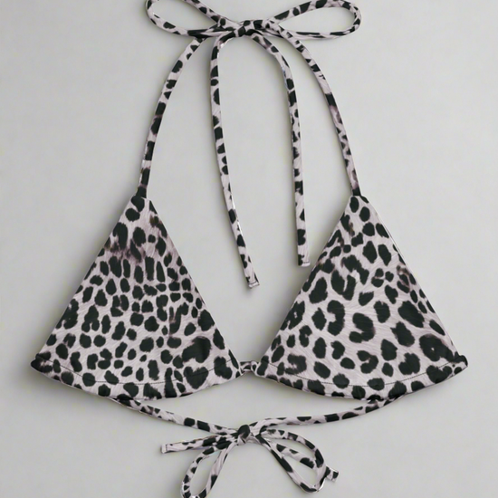 Flat lay of Pixie and Sherbet's Savannah Charge Leopard print bikini top on a light gray background