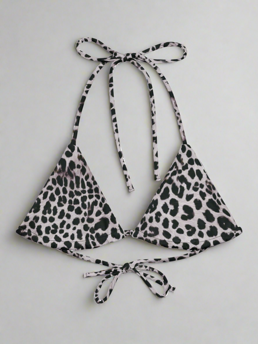 Flat lay of Pixie and Sherbet's Savannah Charge Leopard print bikini top on a light gray background