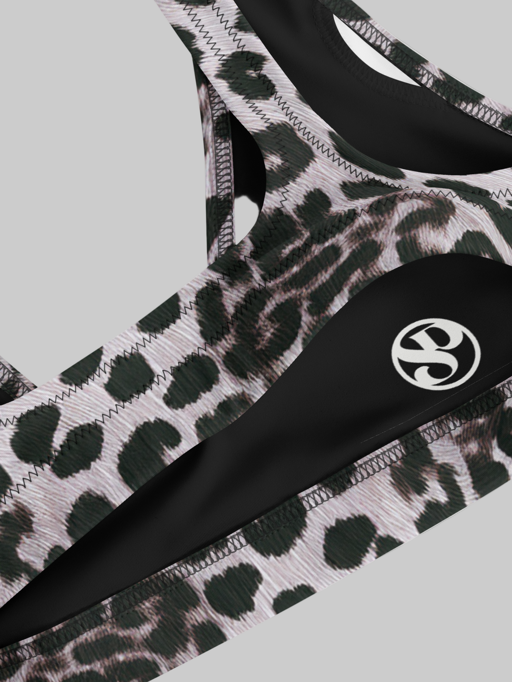 Savannah Charge Surf bikini top in luxe leopard print with contrast black panels and white logo detail; high-performance stretch fabric with sleek stitching for a bold, empowering beach-to-studio look