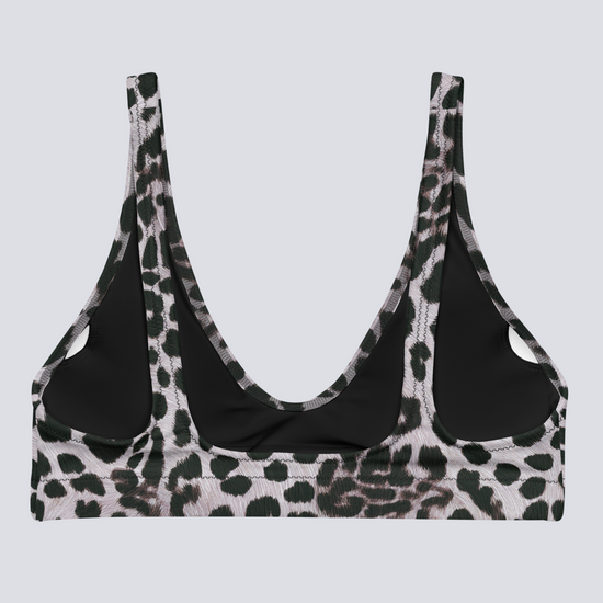 Flat-lay of Savannah Charge Surf Bikini Top in black, white, and dark green leopard print with deep scoop neckline and wide straps – bold, sculpting swimwear by Pixie & Sherbet.