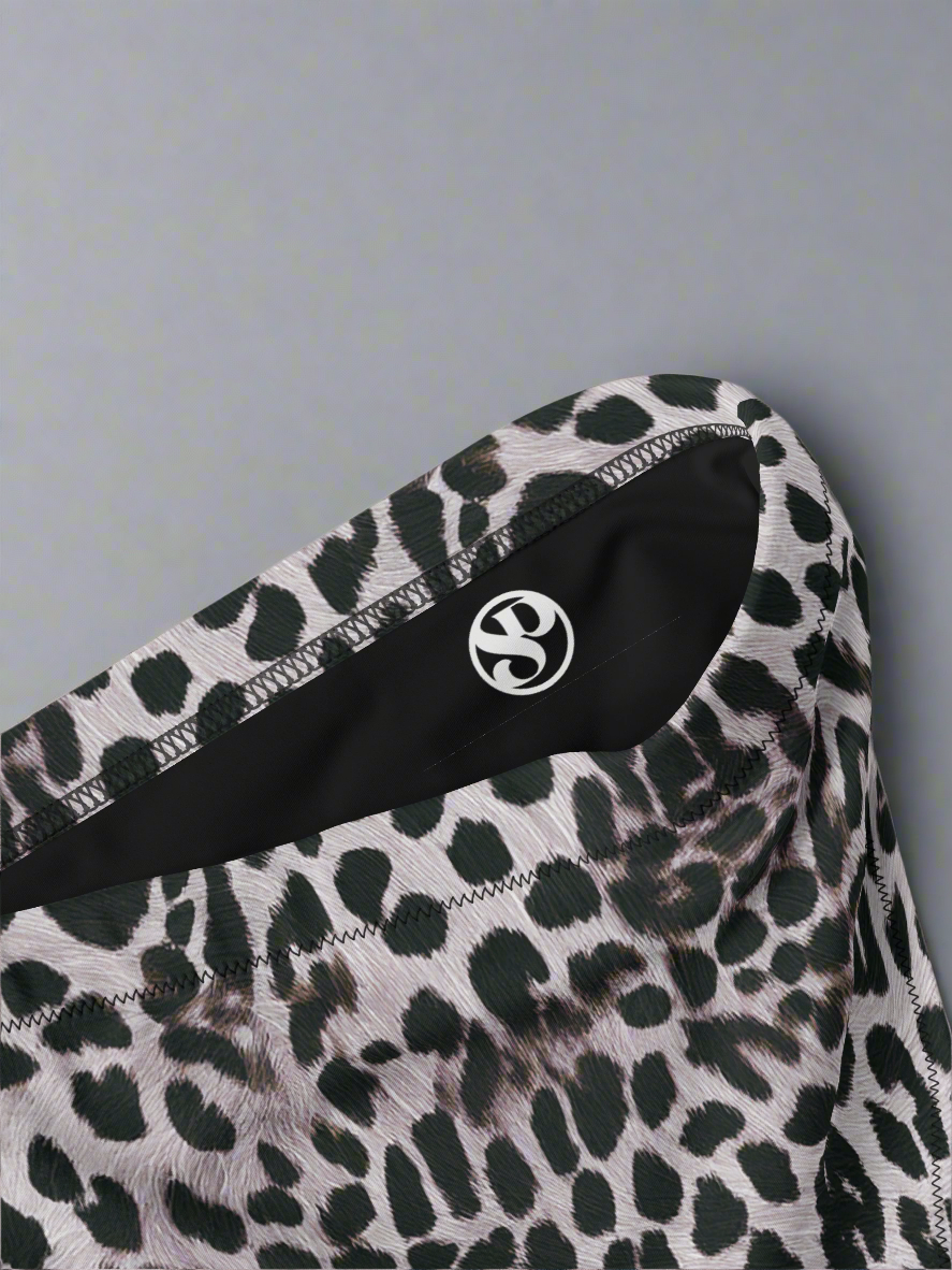 Leopard print fabric with a brand logo on a light gray background