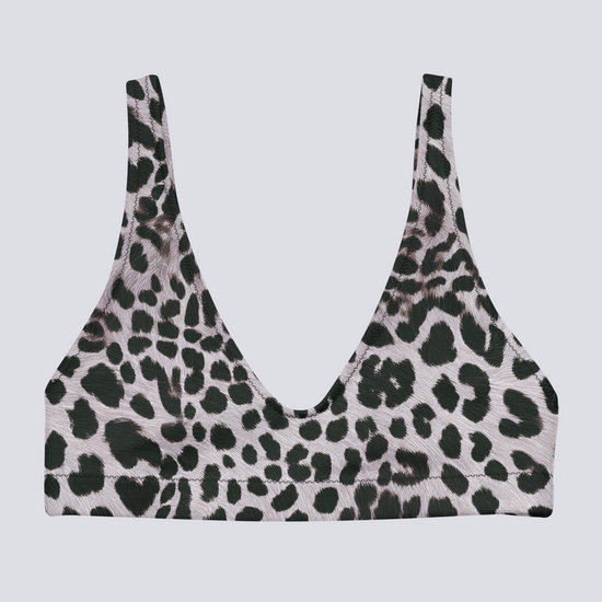 Flat-lay of Savannah Charge Surf Bikini Top in black and white leopard print with deep V-neck and seamless finish – bold, sculpting swimwear by Pixie & Sherbet