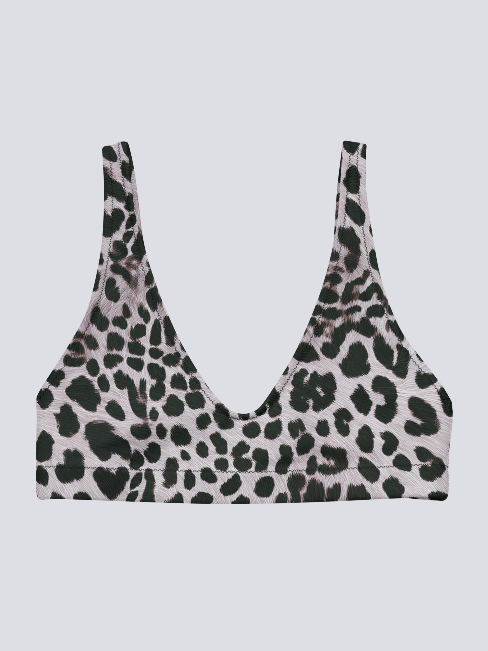 Flat-lay of Savannah Charge Surf Bikini Top in black and white leopard print with deep V-neck and seamless finish – bold, sculpting swimwear by Pixie & Sherbet