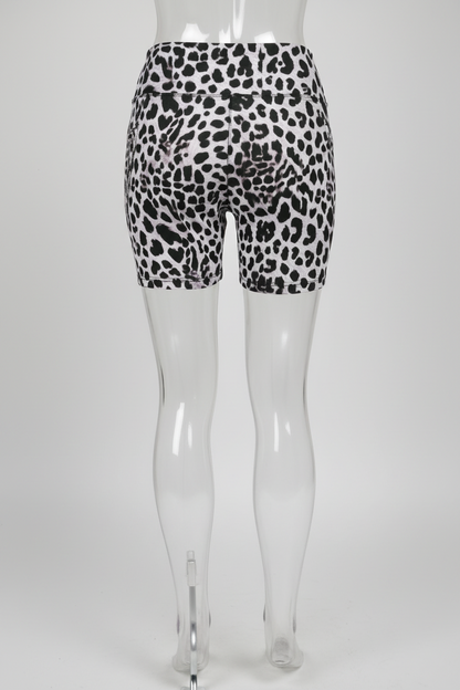 Rear view of a mannequin wearing high-waisted biker shorts with a black leopard print on a white background, shown against a plain white studio backdrop.