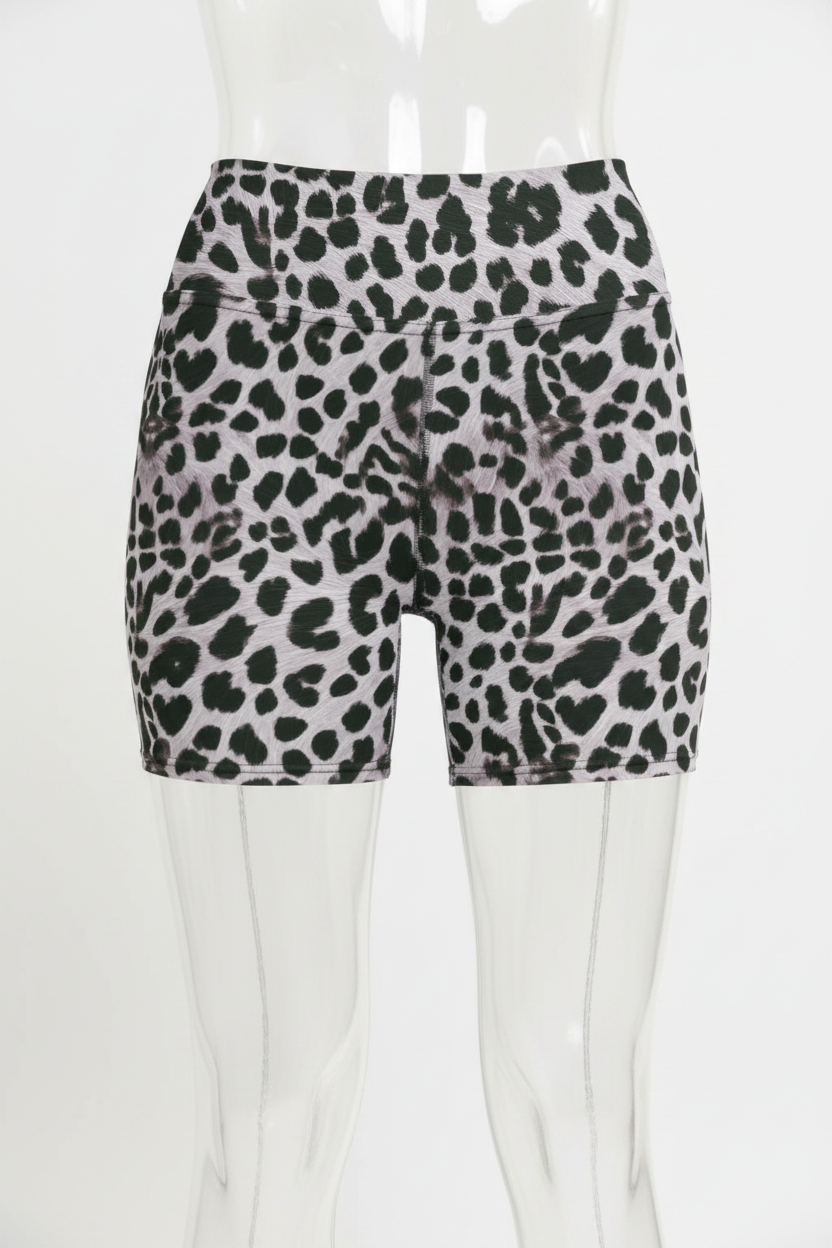 A mannequin wearing high-waisted athletic shorts with a black leopard print pattern on a light pinkish-gray background.
