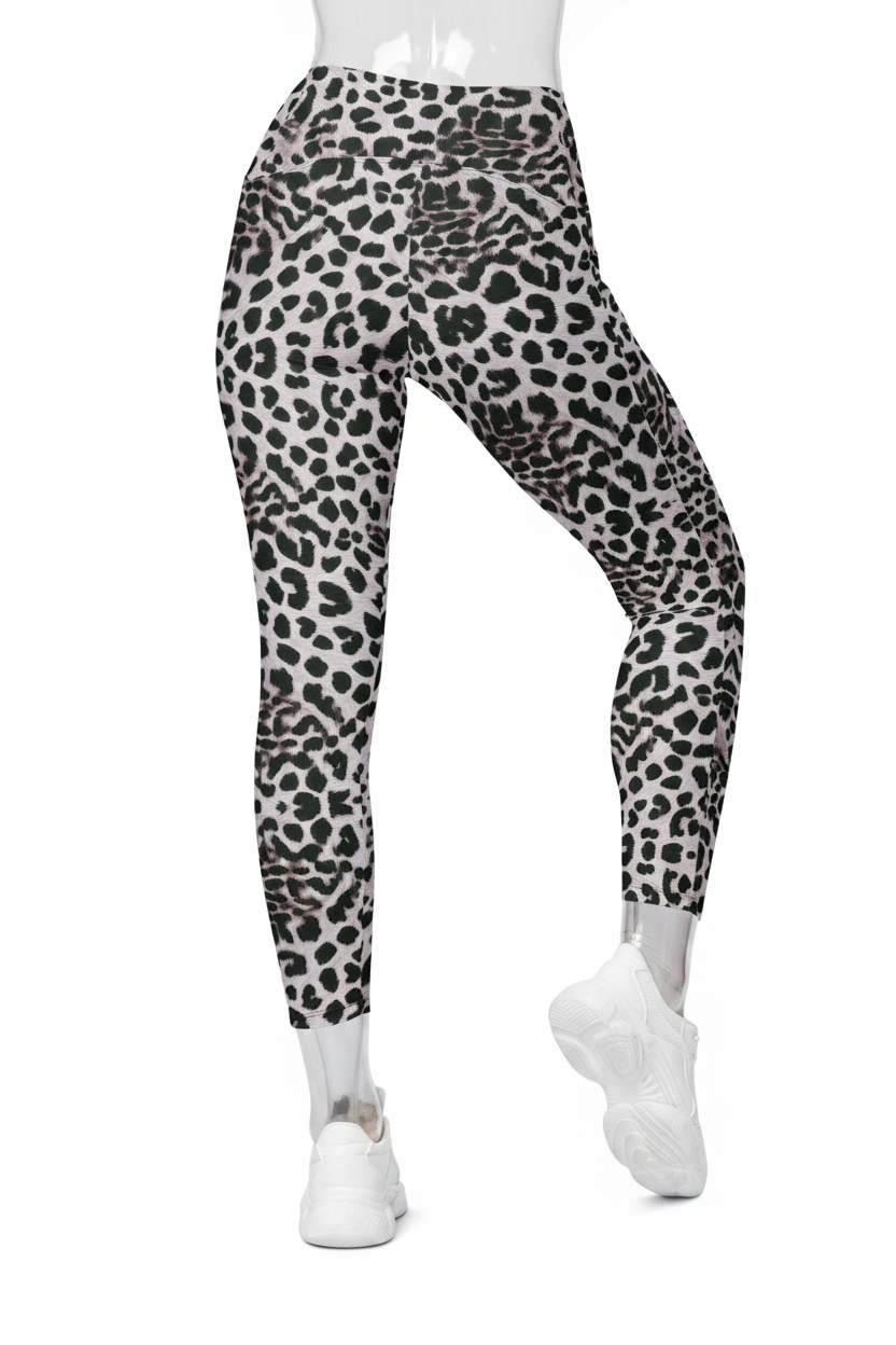 Black and white leopard print leggings shown on a model from the waist down, paired with white sneakers against a plain white background. 