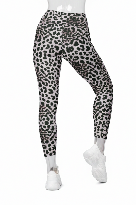 Black and white leopard print leggings shown on a model from the waist down, paired with white sneakers against a plain white background. 