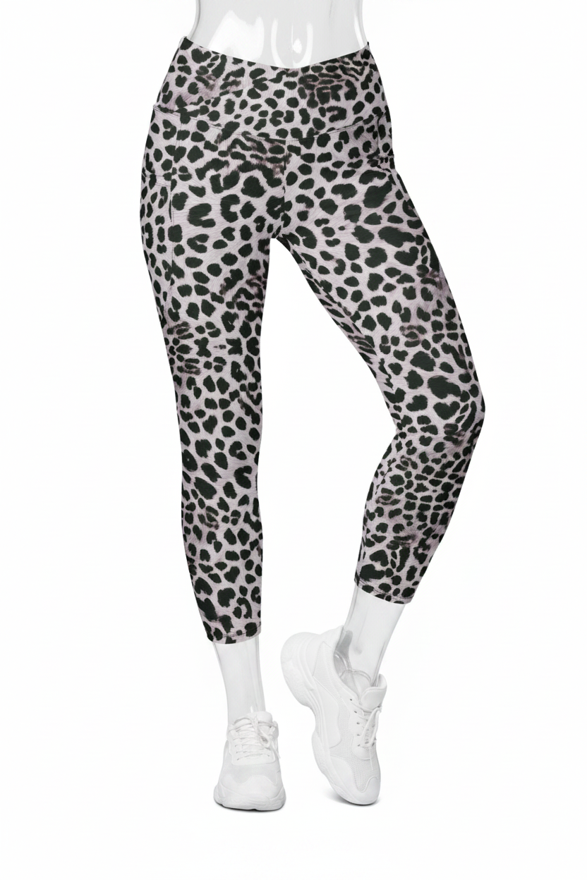 A mannequin modeling high-waisted leggings with a black leopard print on a light gray background, paired with white sneakers against a plain white studio background.
