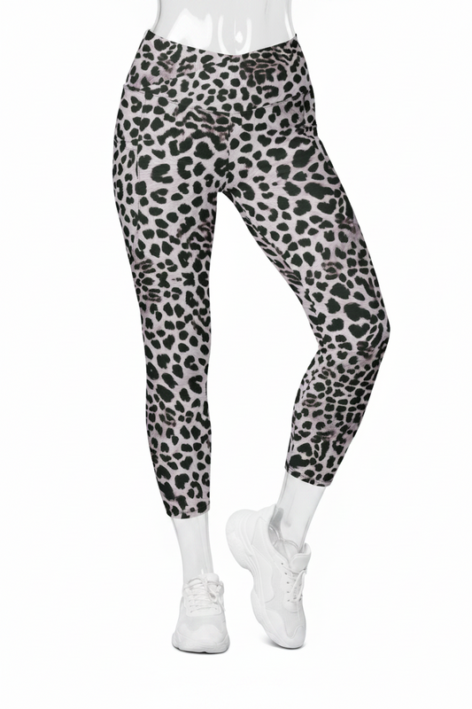 A mannequin modeling high-waisted leggings with a black leopard print on a light gray background, paired with white sneakers against a plain white studio background.